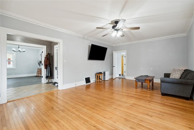 unfurnished living room featuring ornamental molding, ceiling fan with notable chandelier, and light hardwood / wood-style floors