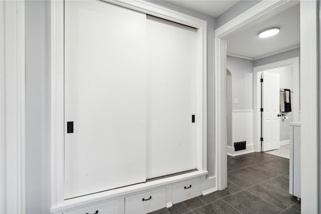 hallway with dark tile patterned flooring