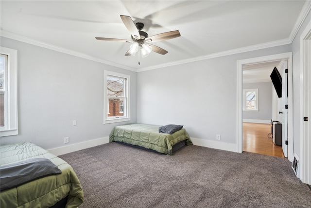 bedroom featuring ceiling fan, ornamental molding, and multiple windows