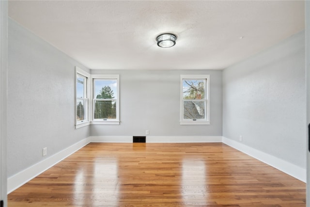 spare room with light hardwood / wood-style floors