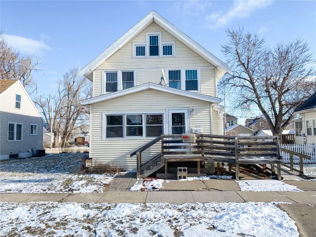 snow covered house featuring a deck