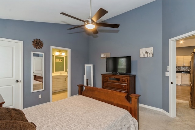 carpeted bedroom with ensuite bath, high vaulted ceiling, and ceiling fan