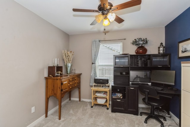 carpeted home office featuring ceiling fan