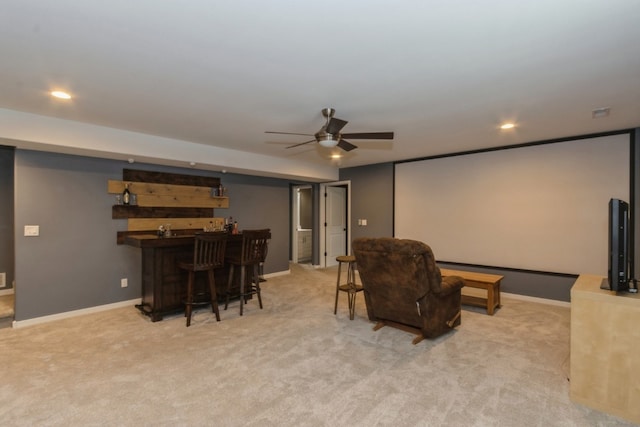 carpeted cinema featuring ceiling fan and bar area