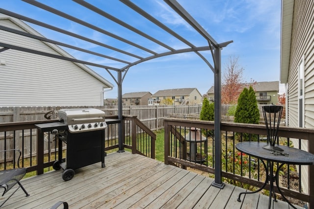 wooden terrace with a grill and a pergola