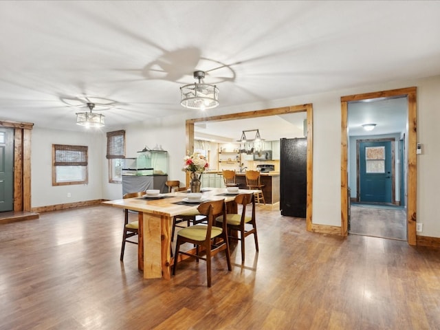 dining room with hardwood / wood-style flooring and ceiling fan