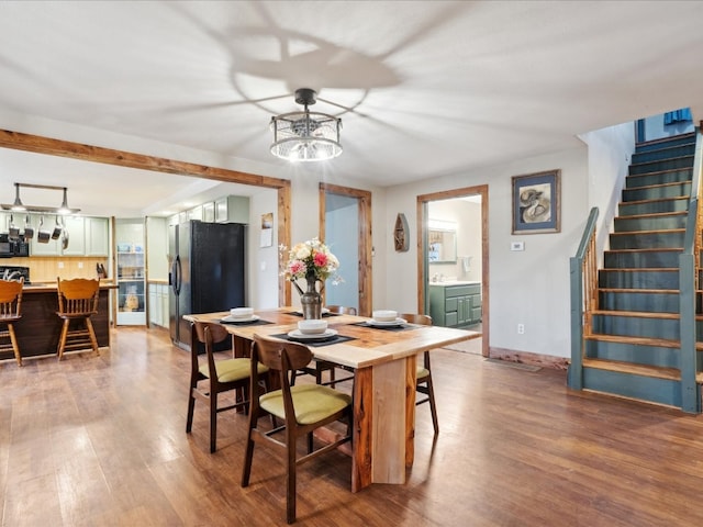 dining space with wood-type flooring