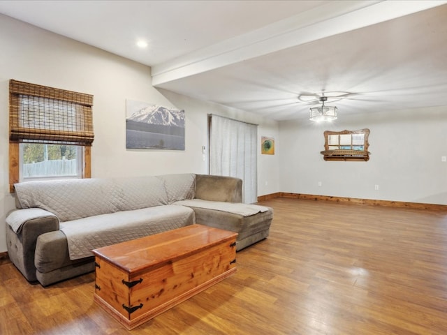 living room featuring light wood-type flooring and ceiling fan