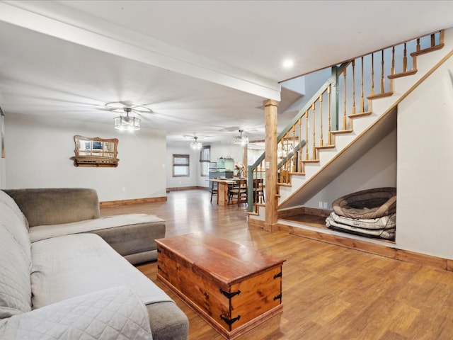 living room with hardwood / wood-style floors and ornate columns