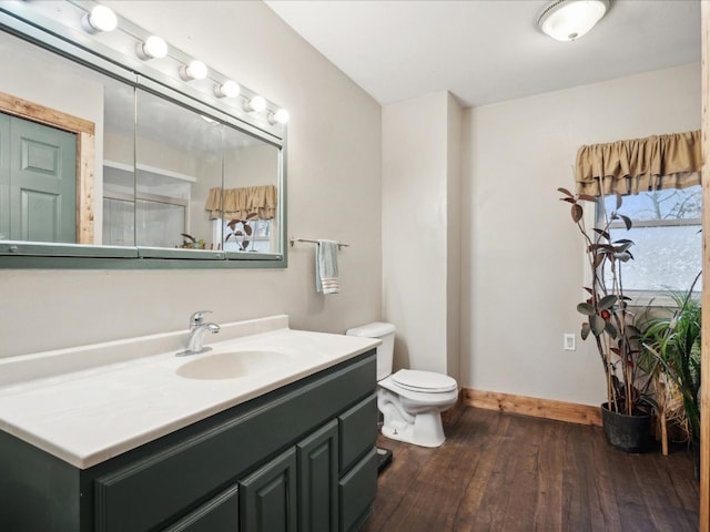 bathroom featuring toilet, hardwood / wood-style floors, and vanity