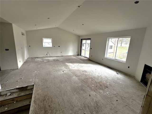 unfurnished living room with lofted ceiling