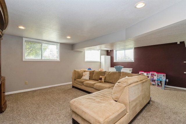 carpeted living room with a textured ceiling and a healthy amount of sunlight