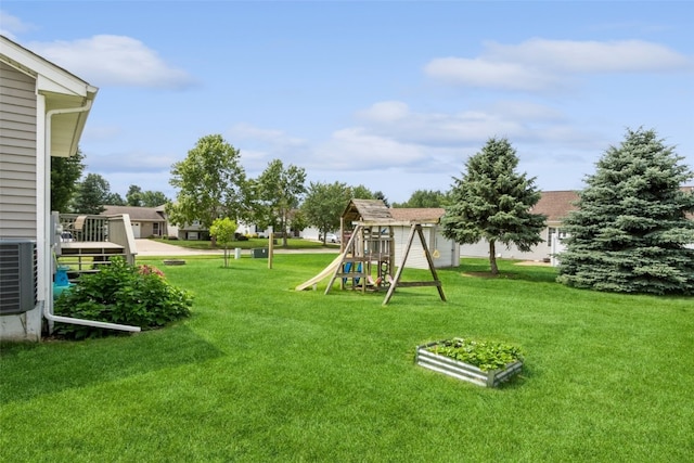 view of yard with central AC unit, a playground, and a deck