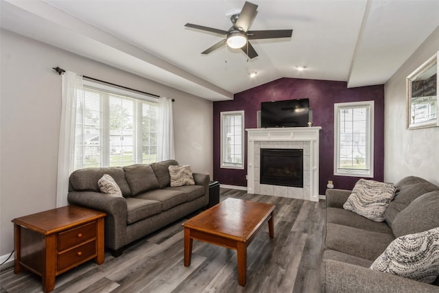 living room featuring a fireplace, hardwood / wood-style flooring, ceiling fan, and lofted ceiling