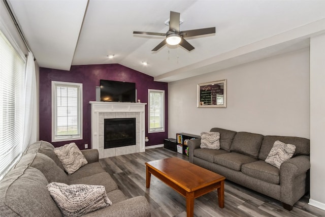 living room featuring hardwood / wood-style floors, a fireplace, lofted ceiling, and ceiling fan