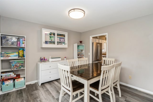 dining room with dark hardwood / wood-style flooring