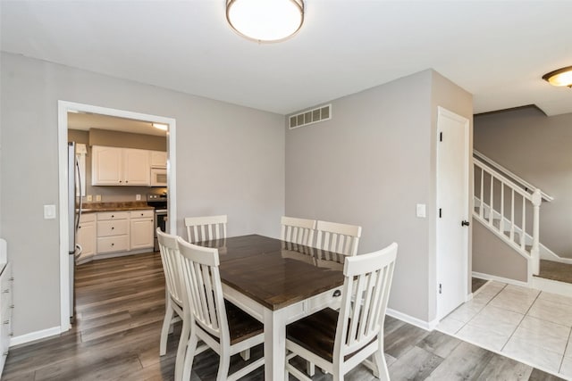 dining room with light wood-type flooring