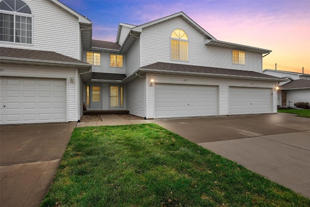 view of front facade featuring a garage and a yard