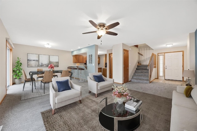 carpeted living room featuring ceiling fan