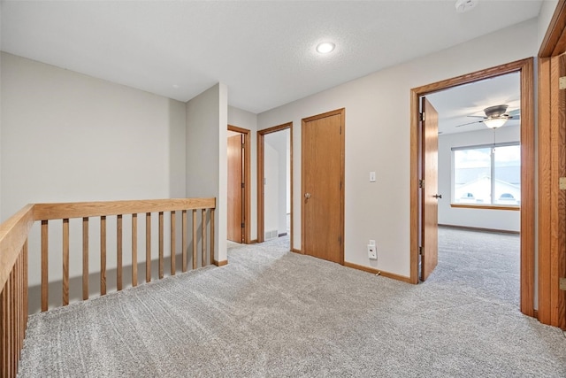 interior space featuring a textured ceiling and light carpet