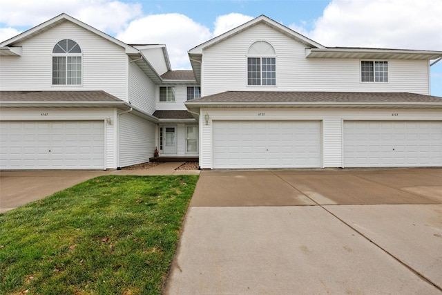 front facade with a garage and a front yard