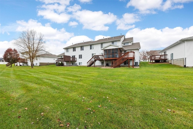 back of house with a lawn and a wooden deck