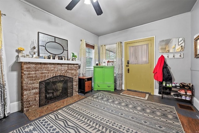 living room with ceiling fan and a fireplace