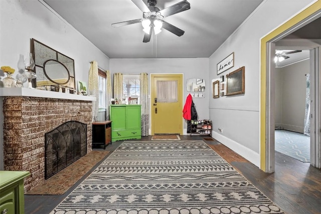 interior space featuring ceiling fan, a fireplace, and dark wood-type flooring