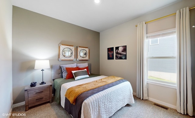 bedroom featuring light colored carpet