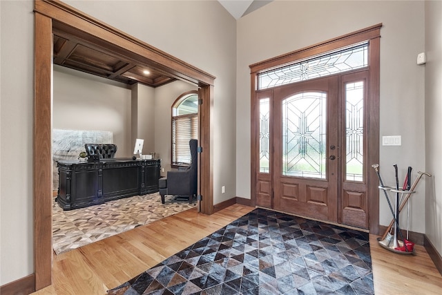 entryway featuring coffered ceiling, hardwood / wood-style floors, and beam ceiling