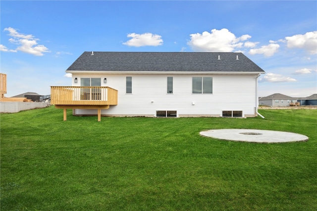 rear view of property featuring a lawn and a wooden deck