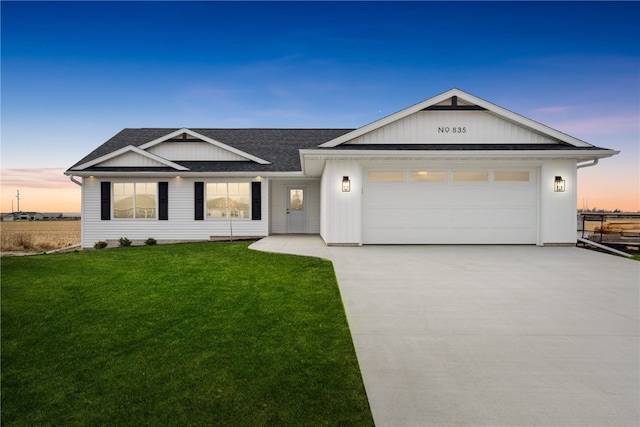 view of front of house featuring a garage and a yard