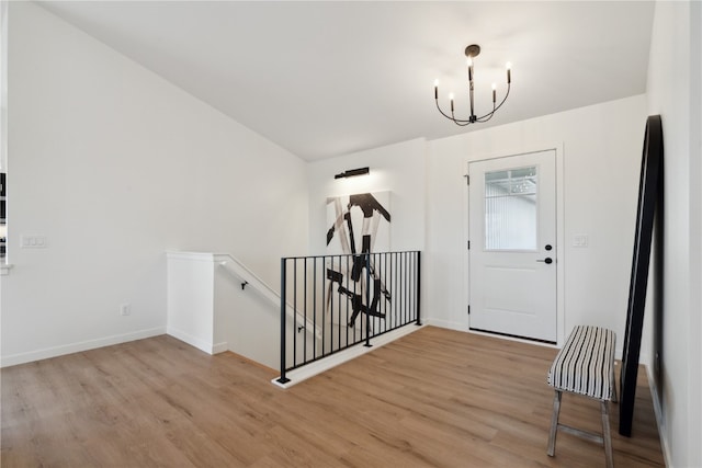 entrance foyer featuring an inviting chandelier and light hardwood / wood-style floors