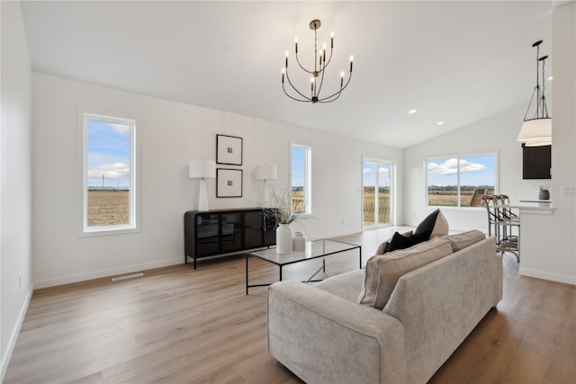 living room featuring light hardwood / wood-style floors and vaulted ceiling