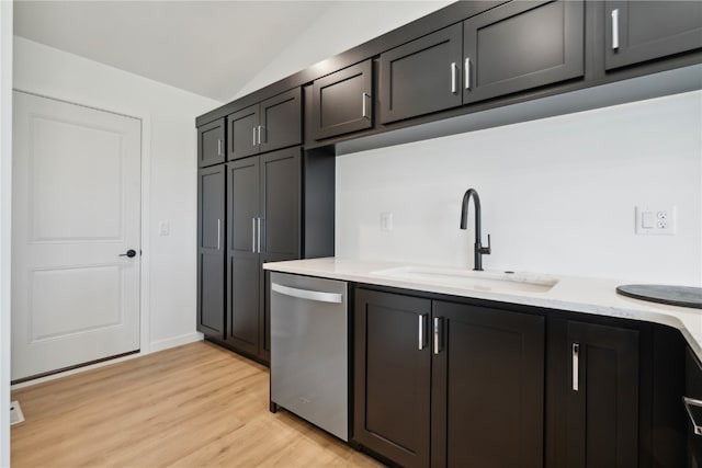 kitchen with light hardwood / wood-style floors, sink, light stone counters, stainless steel dishwasher, and lofted ceiling