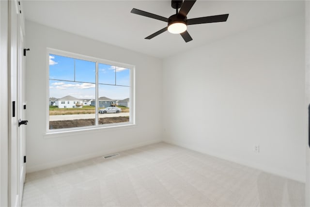 carpeted empty room with ceiling fan