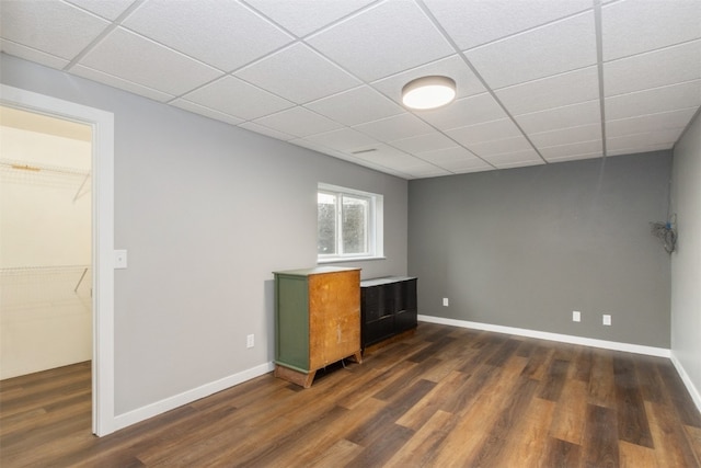 interior space featuring dark hardwood / wood-style flooring and a paneled ceiling