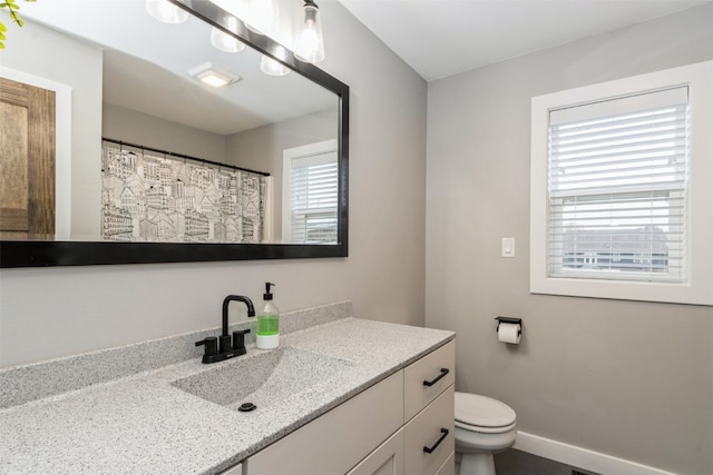 bathroom with vanity and toilet