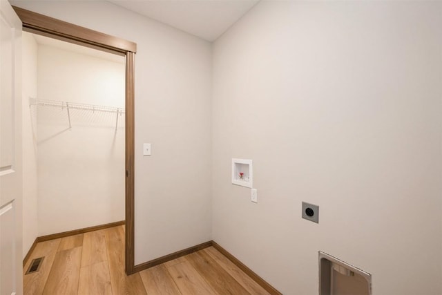 clothes washing area with light wood-style flooring, washer hookup, visible vents, baseboards, and electric dryer hookup