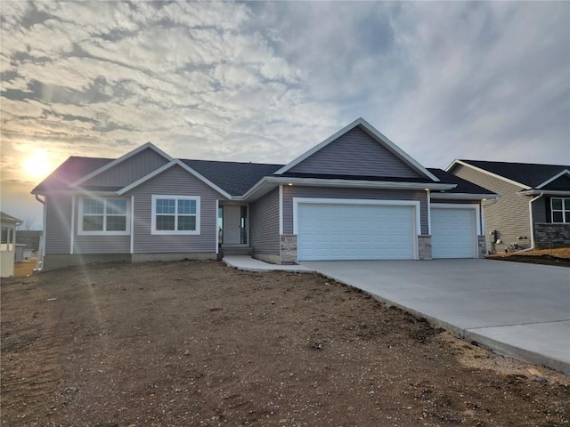 ranch-style home featuring a garage and concrete driveway