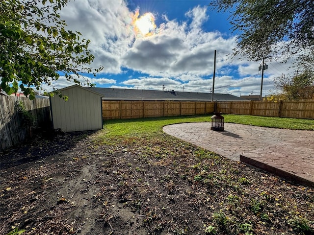 view of yard with a shed and a patio area