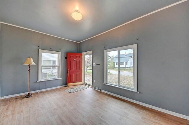 interior space featuring wood-type flooring and crown molding