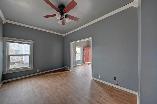 unfurnished room featuring light wood-type flooring, ceiling fan, and ornamental molding