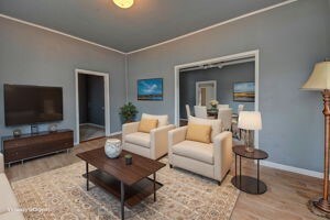 living room featuring wood-type flooring and crown molding