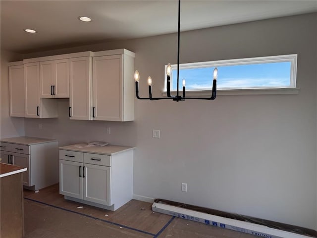 kitchen with white cabinetry, wood finished floors, recessed lighting, and baseboards