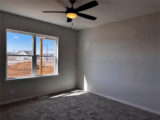 unfurnished room featuring visible vents, a ceiling fan, baseboards, and carpet floors