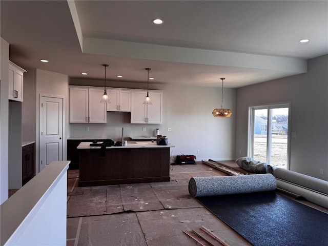 kitchen featuring hanging light fixtures, white cabinets, recessed lighting, and open floor plan