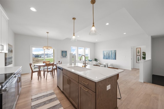1932 Bowstring Dr, Marion, IA 52302 - kitchen with a sink, stainless steel appliances, light countertops, light wood-style flooring, and pendant lighting