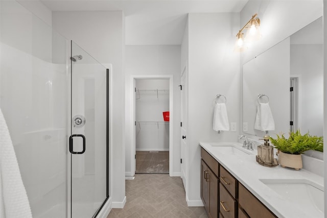 1932 Bowstring Dr, Marion, IA 52302 - full bathroom with a stall shower, a walk in closet, double vanity, and baseboards