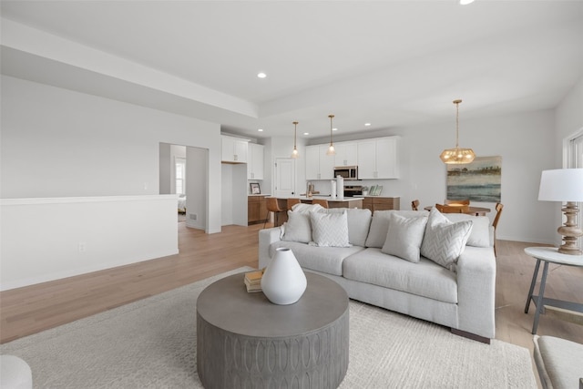 1932 Bowstring Dr, Marion, IA 52302 - living room with light wood finished floors, recessed lighting, baseboards, and a chandelier
